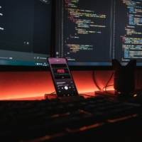a keyboard with a dark screen with code lines
